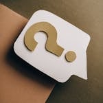 Artistic paper craft of a question mark on neutral background. Ideal for concept themes.